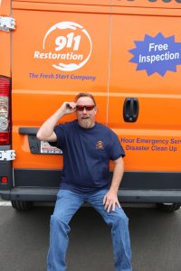 911-restoration-water-damage-mold-remediation-fire-damage-person-van-sunglasses